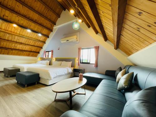 a hotel room with a bed and a couch at 大方來富莊園民宿DF Life Lodge in Yongan