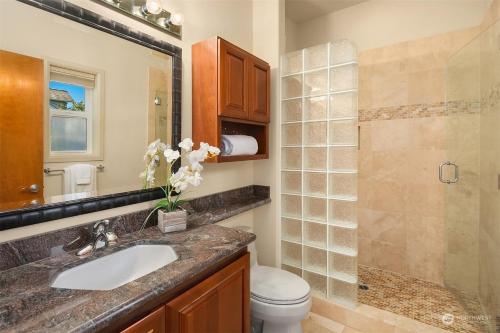 a bathroom with a sink and a toilet and a shower at LakeFront- Private studio on Lake Sammamish in Bellevue