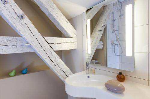 a bathroom with a sink and a mirror at ibis Styles Chaumont Centre Gare in Chaumont