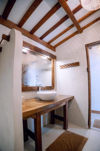 a bathroom with a sink and a mirror at Island View Bar & Bungalow in Gili Air