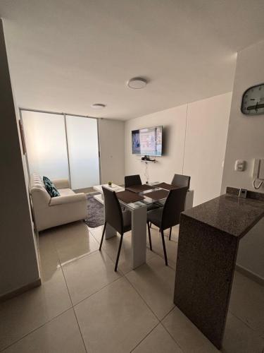 a living room with a table and chairs and a couch at Apartamento Moderno y Comodo in Cúcuta
