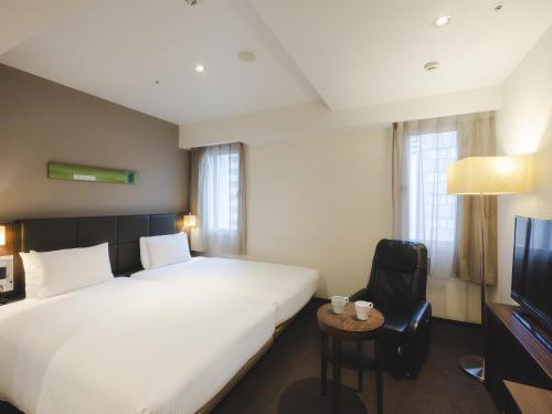 Postel nebo postele na pokoji v ubytování Hotel Gracery Tokyo Tamachi