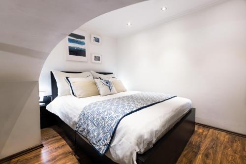 A bed or beds in a room at Budapest Downtown Museum Apartments