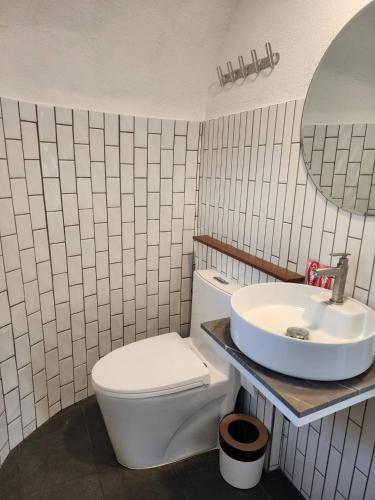 a bathroom with a white toilet and a sink at Sky The Campers in Chiang Dao