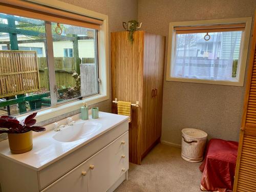 a bathroom with a sink and a window at Central Māngere Bridge Gem in Auckland