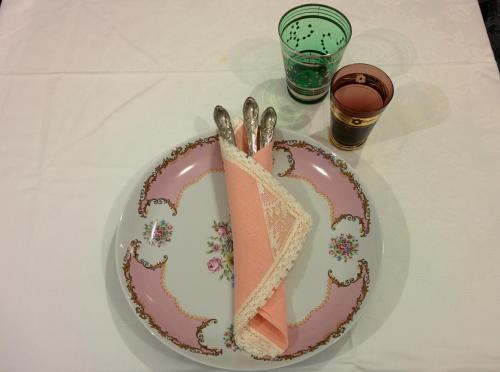 a plate with a cake on a table with a napkin at Ciauru Design B&B in Messina
