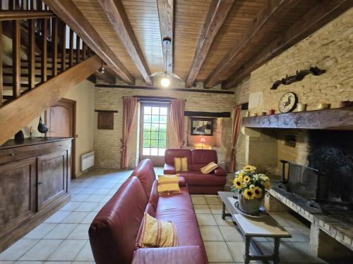 a living room with a couch and a fireplace at Charmante maison périgourdine avec jardin, cheminée et proche de Sarlat - FR-1-616-88 in Salignac Eyvigues