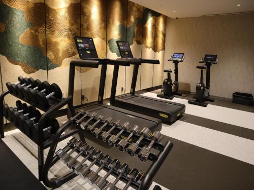 a gym with treadmills and elliptical machines at THE BLOSSOM KYOTO in Kyoto