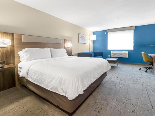 a hotel room with a large bed and a window at Holiday Inn Express Salt Lake City South - Midvale by IHG in Midvale