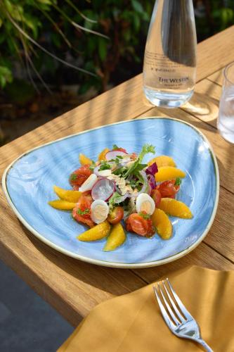 a blue plate of food on a wooden table at The Westin Resort & Spa Cam Ranh in Cam Ranh