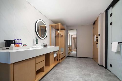a bathroom with a sink and a mirror at Hilton Garden Inn Chengde Mountain Resort in Chengde