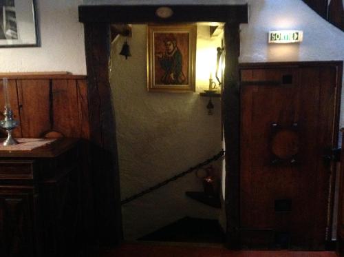 a hallway of a house with a clock on the wall at Auberge des Seigneurs in Vence