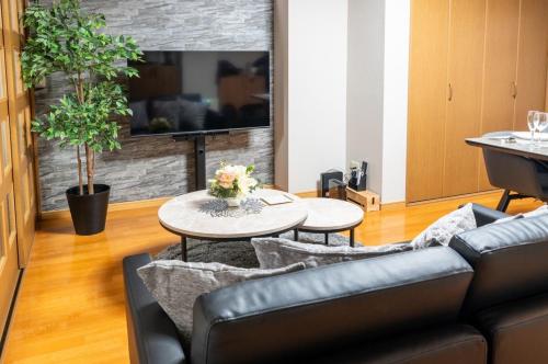 a living room with a couch and a table at Za086 柏原ビル101 in Tokyo