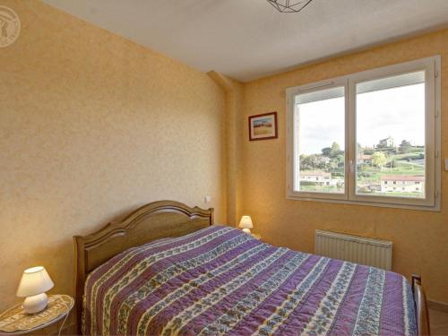 a bedroom with a bed and a window at Gîte rural avec jardin, parking et WiFi - Saint-Romain-en-Jarez - FR-1-496-295 in Saint-Romain-en-Jarez