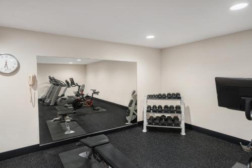 a room with a gym with a treadmill and a mirror at Holiday Inn Express & Suites Hayward by IHG in Hayward