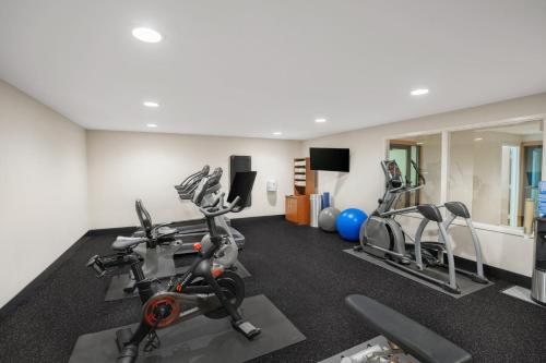 a gym with two treadmills and two exercise bikes at Holiday Inn Express & Suites Hayward by IHG in Hayward