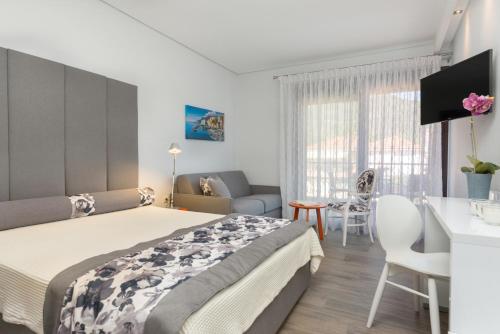 a bedroom with a large bed and a table at Mary's Luxury in Chrysi Ammoudia