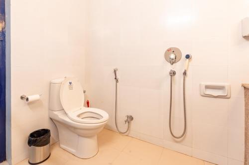 a bathroom with a toilet and a shower at Gopagiri Homestay - Gwalior in Gwalior