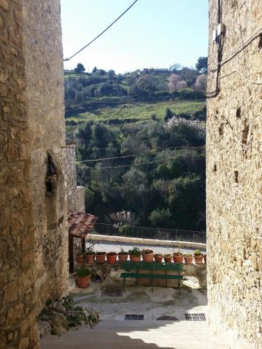 a view from an alley with a table and potted plants at Case Vacanza Al Borgo Antico in Vico del Gargano