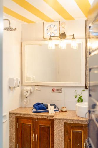 a bathroom with a sink and a mirror at Gopagiri Homestay - Gwalior in Gwalior