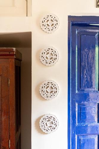 a blue door with plates on a wall next to a door at Gopagiri Homestay - Gwalior in Gwalior