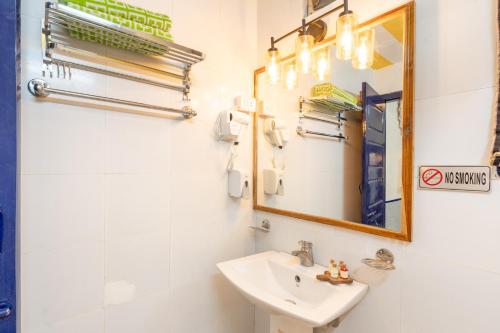 a bathroom with a sink and a mirror at Gopagiri Homestay - Gwalior in Gwalior