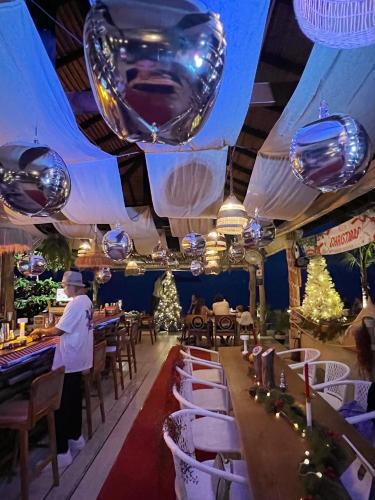 a restaurant with christmas decorations and a chef in the middle at Siam Cookies Cottage in Haad Pleayleam