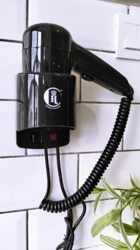 a black telephone hanging on a wall at Silvan Garden Cameron Highlands in Tanah Rata