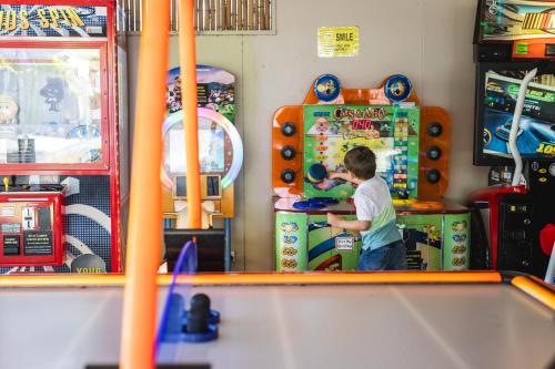 a young boy playing a video game in a toy store at Ivory Palms Resort Noosa in Noosaville
