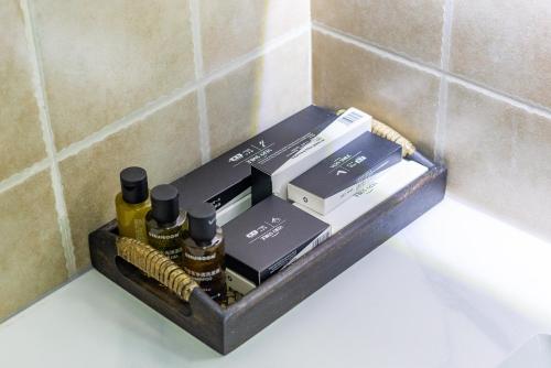 a shelf in the corner of a bathroom with bottles ofologne at September Republic of China Residence in Qingdao in Qingdao