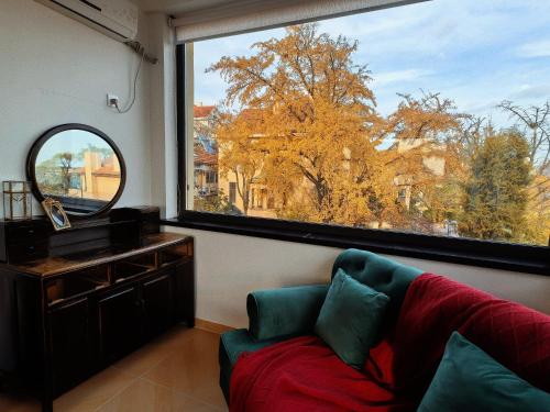 a living room with a couch and a large window at September Republic of China Residence in Qingdao in Qingdao