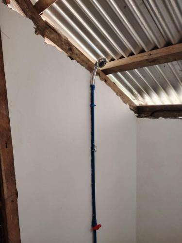a room with a metal ceiling and a pipe at Ocam Ocam Sea Front Cottages in Busuanga