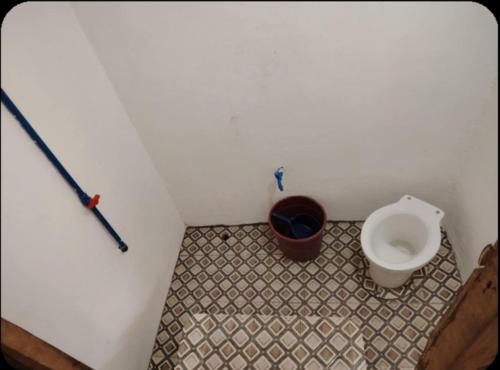 a bathroom with a toilet and a bidet at Ocam Ocam Sea Front Cottages in Busuanga