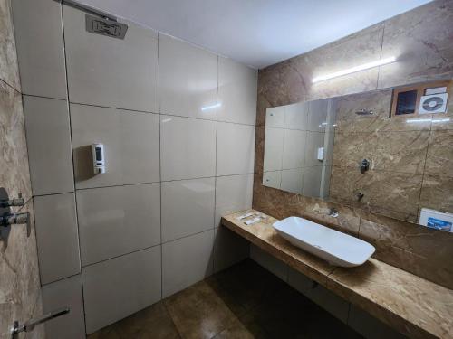 a bathroom with a sink and a mirror at Diga vista resorts in Palakkad