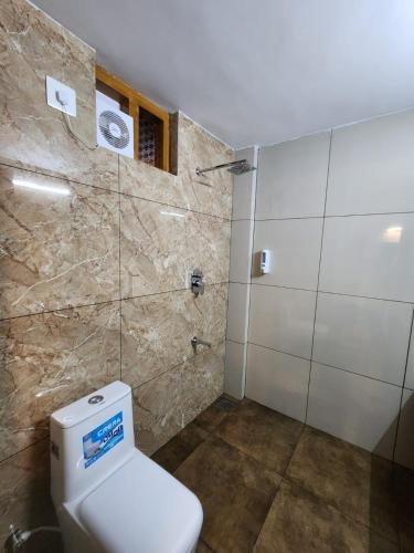 a bathroom with a toilet and a shower at Diga vista resorts in Palakkad