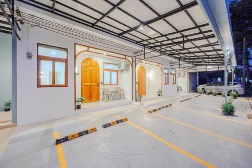an empty garage with a car parked in it at Bania 813 House in Khao Lak