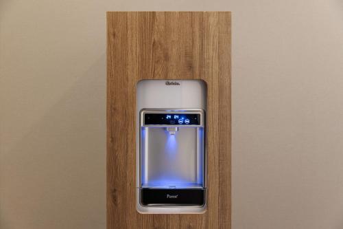 a cell phone is sitting on a wooden shelf at Four Points Flex by Sheraton Kobe Sannomiya in Kobe