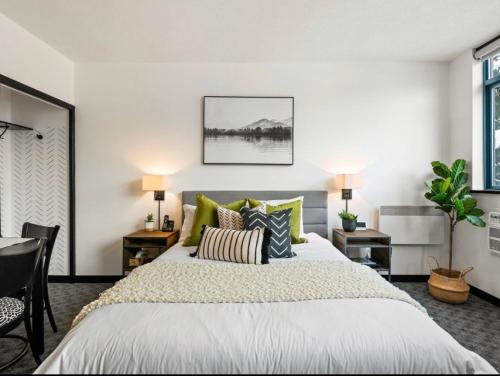 a bedroom with a large bed with green pillows at Ideal Central Village Location! in Whistler