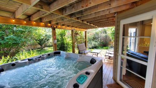 a large jacuzzi tub on a patio at Airdrie Modern Walkout Bsmt Suite with Hot Tub in Airdrie