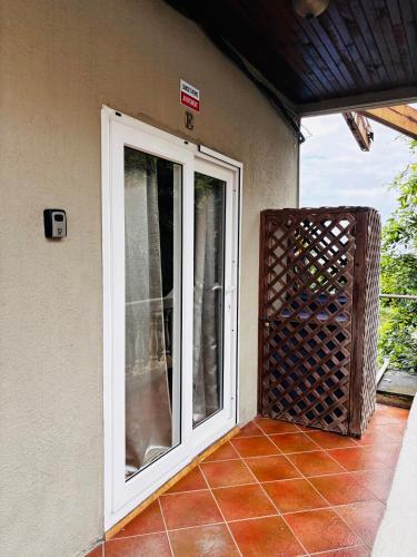 an open door to a patio with a fence at Sunset Views Apartment, West End in West End