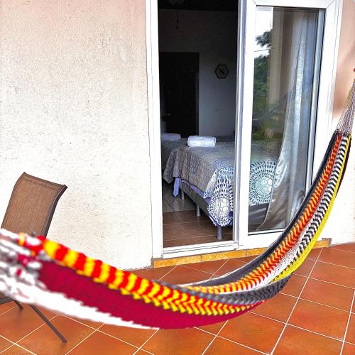 a hammock in front of a room with a table at Sunset Views Apartment, West End in West End