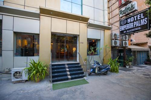 a scooter parked in front of a building at Alaya Stays Hotel Emperor Palms in New Delhi