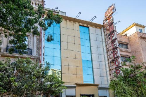 a building with a sign on the side of it at Alaya Stays Hotel Emperor Palms in New Delhi