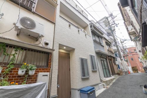a building with a fan on the side of it at 住舎桜ノ宮 in Osaka