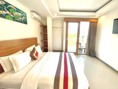 Ένα ή περισσότερα κρεβάτια σε δωμάτιο στο GM Guest House Canggu