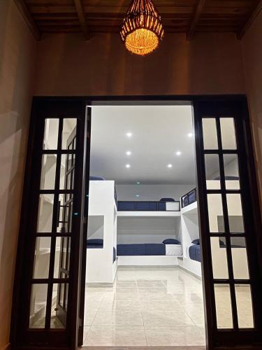 a room with a room with two beds and a chandelier at Río Celeste Poshtel Tayrona - Zaino in Calabazo