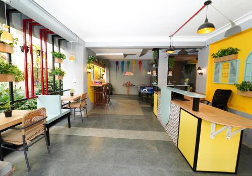 a restaurant with tables and chairs in a room at Vib O Stay in Pune