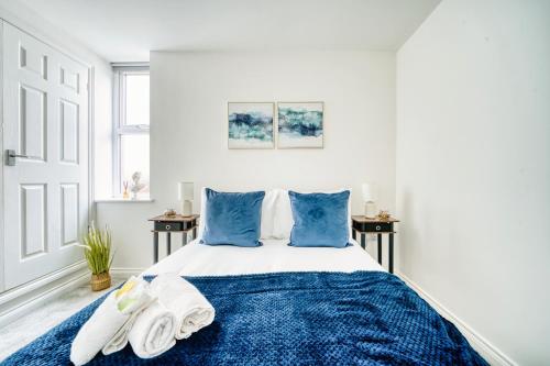 カーディフにあるStunning 2 Bed by the City Centre & Bute Parkの青いシーツと枕が備わったベッドのある寝室
