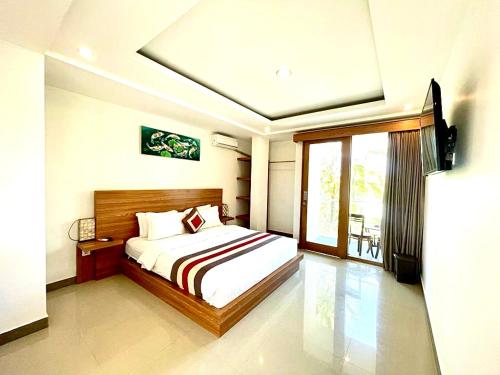 Ένα ή περισσότερα κρεβάτια σε δωμάτιο στο GM Guest House Canggu