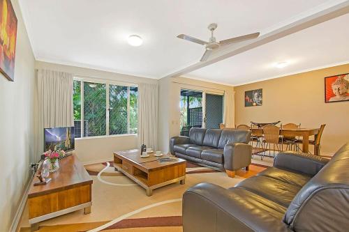 a living room with a couch and a table at Ivory Palms Resort Noosa in Noosaville